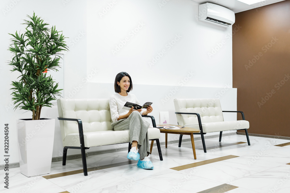Fototapeta premium Cute young girl is being examined by the dentist