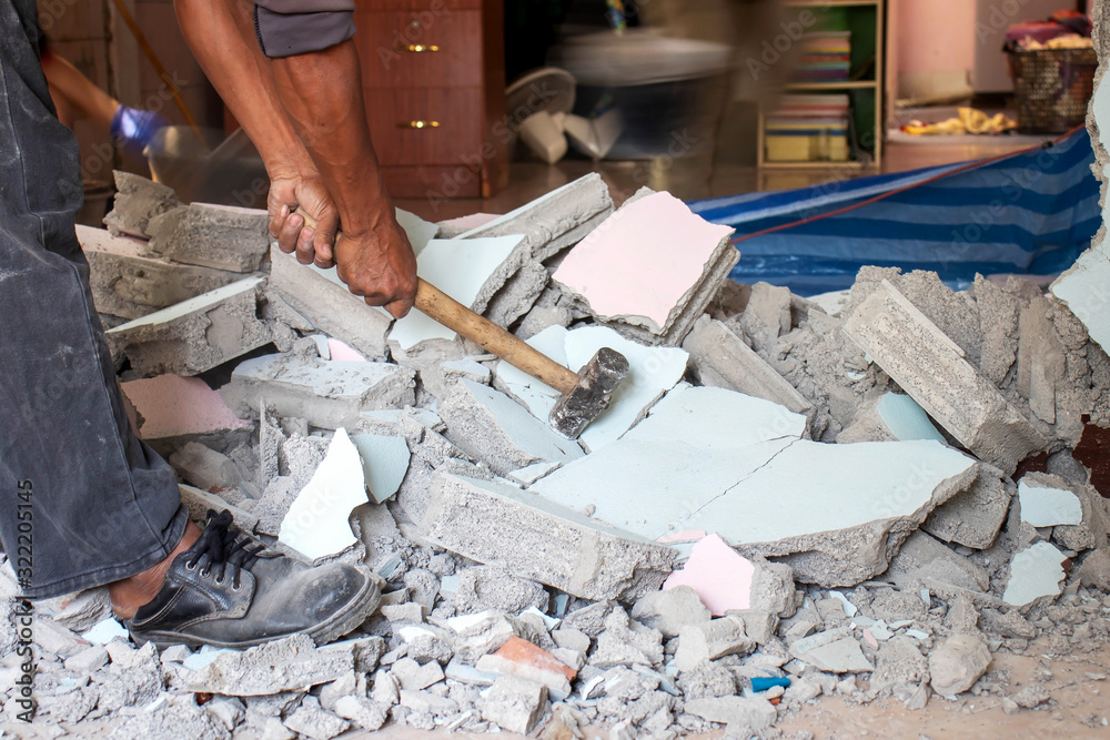 Construction workers are using hammer to break walls and broken walls