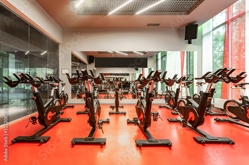 Stationary Spinning bicycles. Indoor cycling for lifestyle design. Fitness background. Healthy lifestyle background. Spinning class with empty bikes. Sport background. Sport, recreation, lifestyle