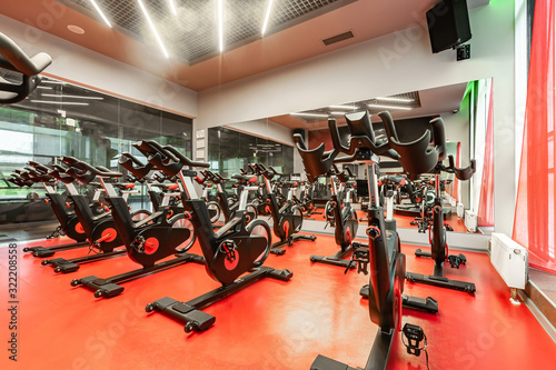 Stationary Spinning bicycles. Indoor cycling for lifestyle design. Fitness background. Healthy lifestyle background. Spinning class with empty bikes. Sport background. Sport, recreation, lifestyle