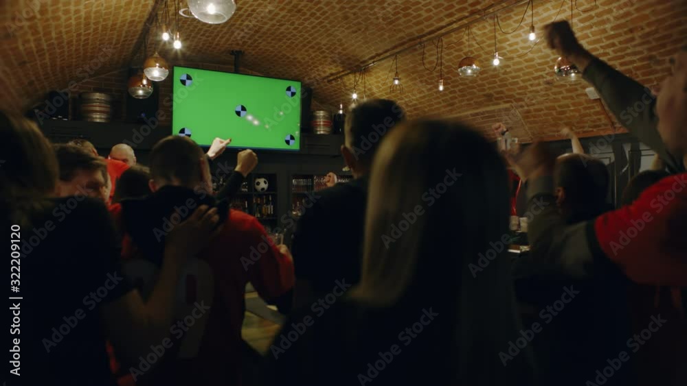 MED FIXED Model released, fans watching a game on a large TV in a sport ...