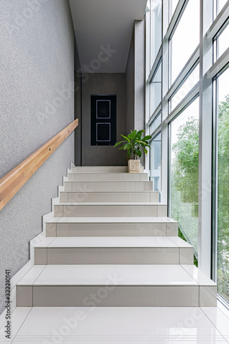 Green staircase window in modern style on white background. Interior design wall. Modern interior design. Modern stylish apartment. Concrete wall. Bright interior.