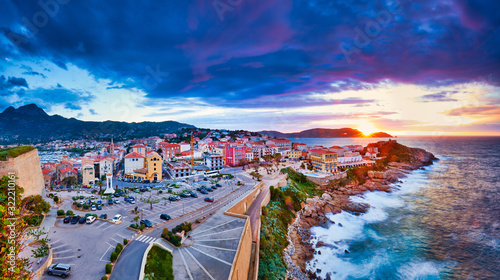 Amazing sunset view from the walls of the citadel of Calvi, the old town with historic buildings. Luxurious marina and very popular tourist destination. Corsica, France, Europe.