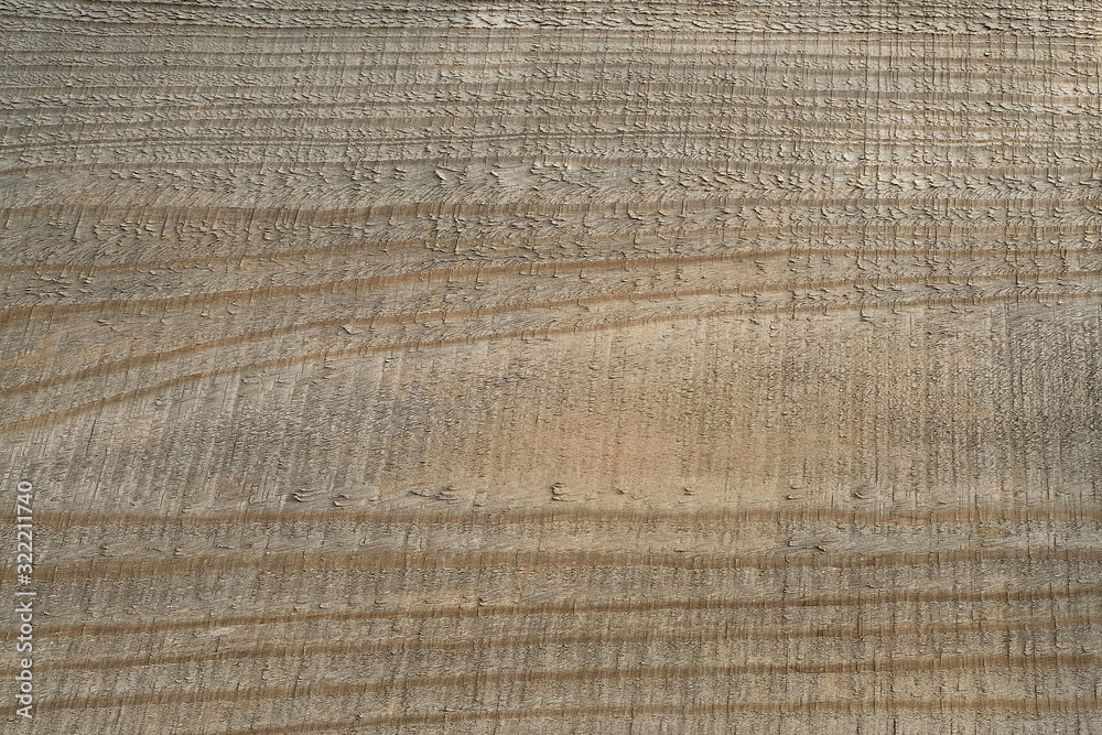 High angle view dark brown rough surface of rustic natural and untreated wooden board for texture and background. Old rough lumber with horizontal pattern. High angle view dark brown rough surface of rustic natural and untreated wooden board for texture and background. Old rough lumber with horizontal pattern.