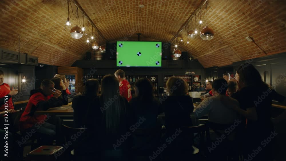 WIDE FIXED Model released, fans watching a game on a large TV in a ...