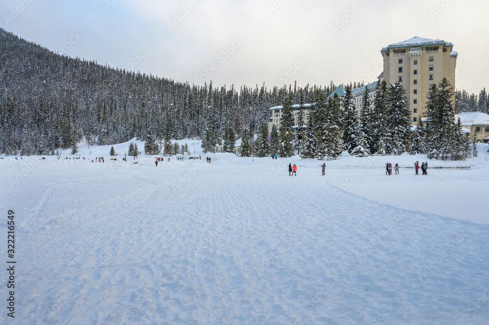 People ski, skate and hike on frozen Lake Louise in Banff National Park, Alberta, Canada