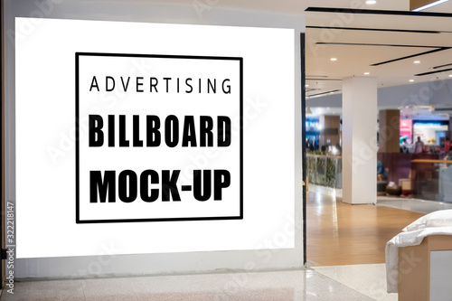 Mock up large blank horizontal billboard on wall near entrance