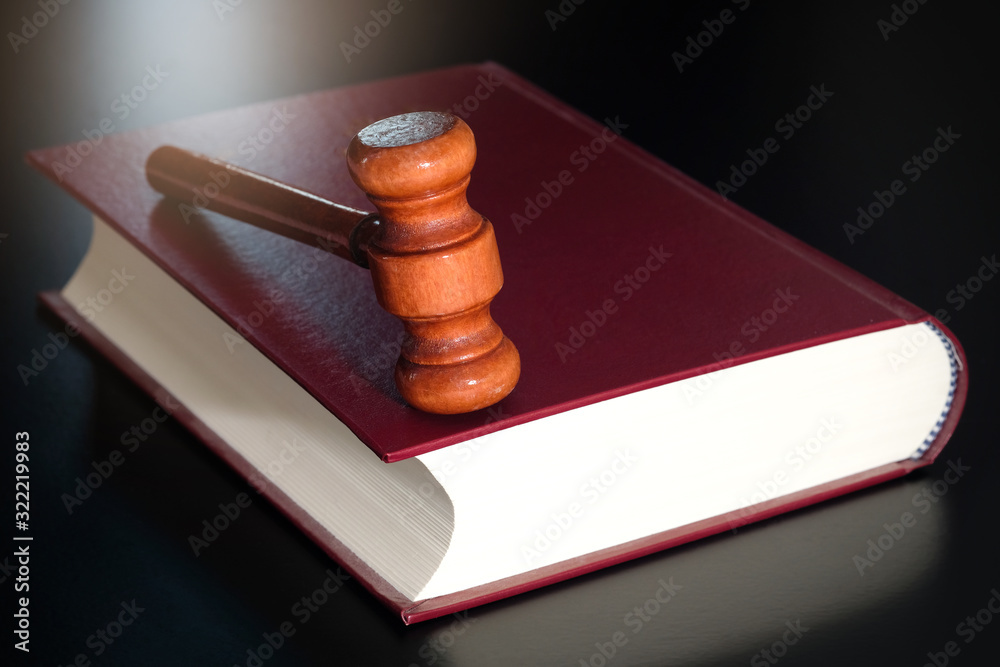 Judge's hammer Put on law books. On a black background . law concepts and protection