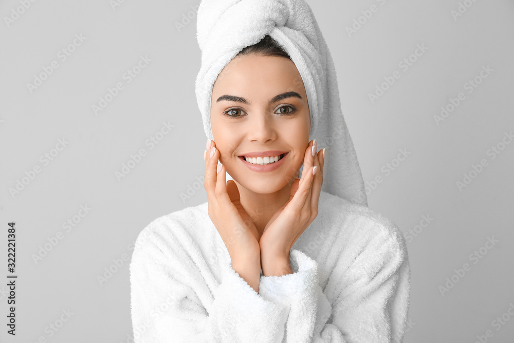 Beautiful young woman after shower on grey background Beautiful young woman after shower on grey background
