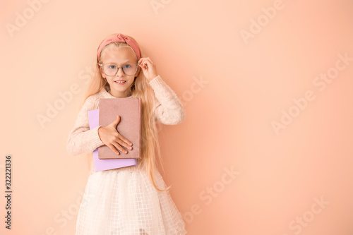 Little girl with books on c...