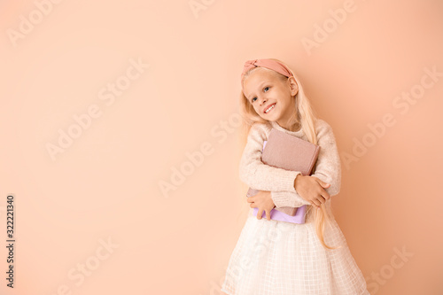 Little girl with books on c...
