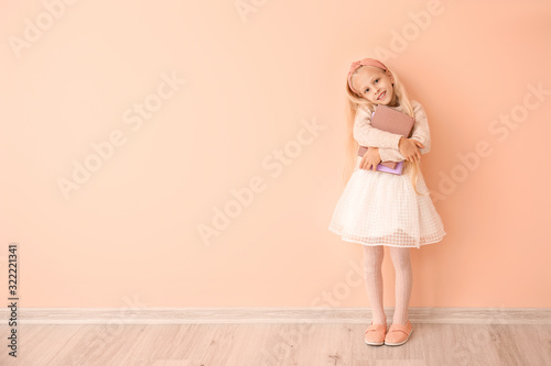 Little girl with books near...