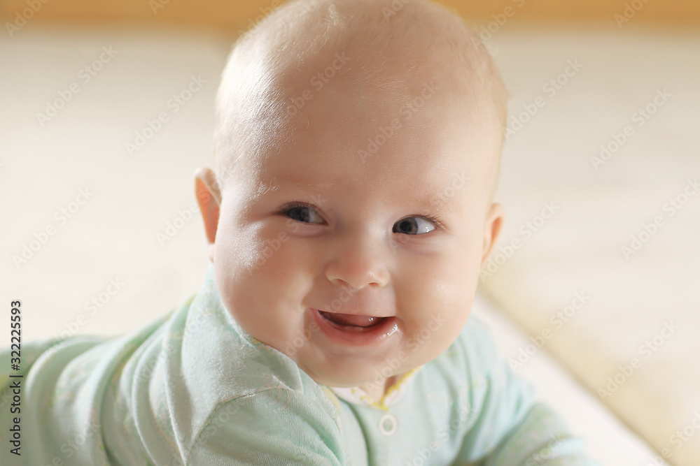 close up.portrait of a pretty little baby on blurred background.
