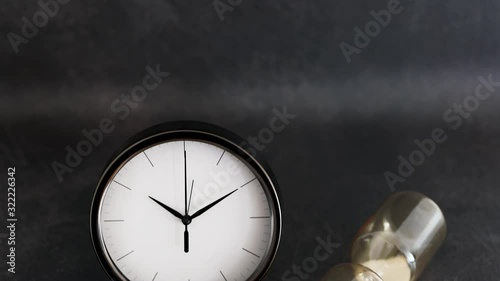 Wallpaper Mural past and present concept, clock and hourglass symbol of old and new lifestyles with camera panning vertically Torontodigital.ca