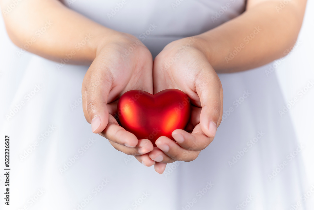 Female hands holding red heart in hands, giving heart, valentine day, closeup. Female hands holding red heart in hands, giving heart, valentine day, closeup.