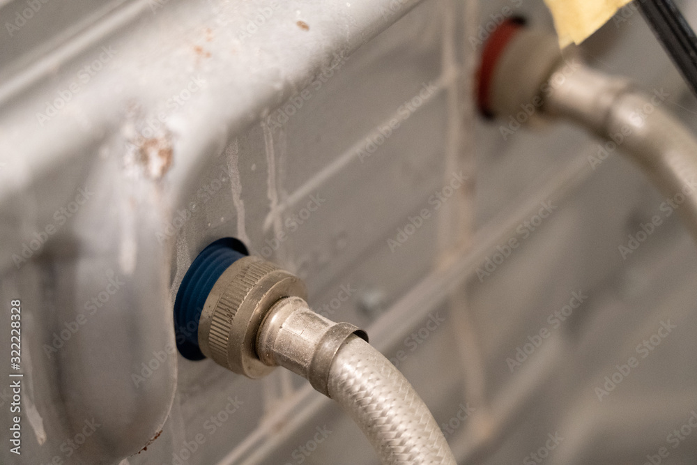 Ταπετσαρία Water hoses attached to the back of a dirty washing machine