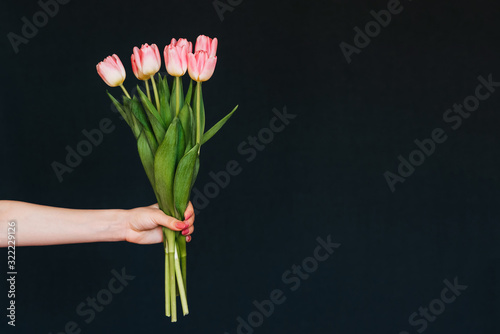 bouquet of pink tulips in the girl's hand