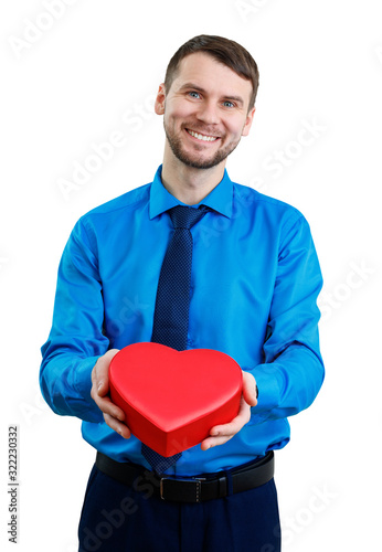 Elegant man with valentines gift box in the shape of heart. © Dmitrii Kotin