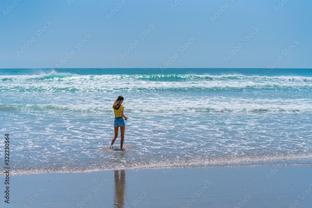 Teenage girl standing on beach