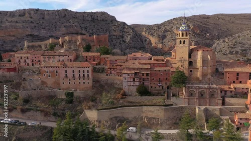 Flying over Albarracin in Teruel Spain, with red sandstone terracotta medieval houses, Moorish castle and ancient city walls  voted most beautiful Spanish village photo