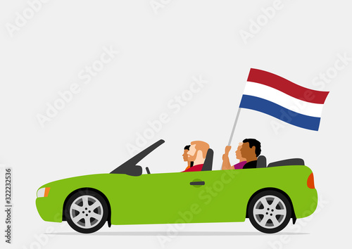 People in car with netherlands flag