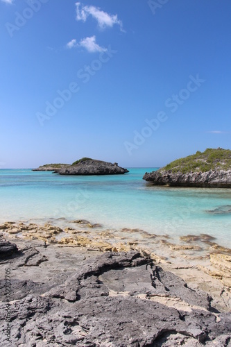 Rocky Caribbean shoreline with vibrant turquoise water and small islands © Gabe Shakour