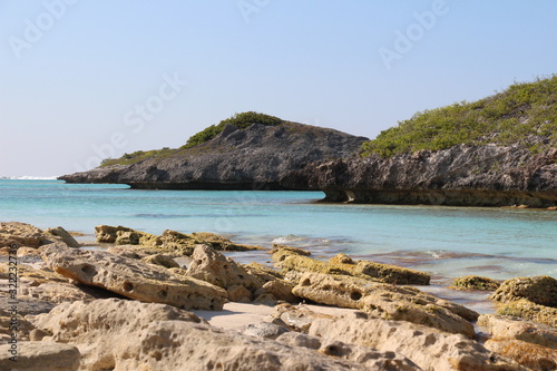 View along rocky tropical Caribbean shoreline with turquoise blue ocean in Turks and Caicos