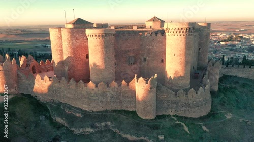 Aerial panorama view of Belmonte castle in Cuenca province Spain with long stretching city walls topped with battlements