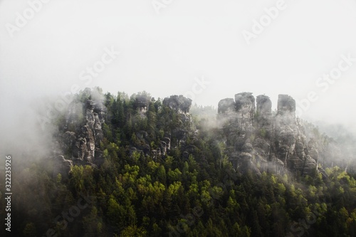 Panoramic view of the Elbe Sandstone Mountains covered in fog in Saxony, Germany photo