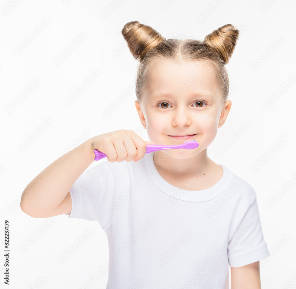 Little girl with a toothbrush in a white T-shirt on a white isolated background. Little girl with a toothbrush in a white T-shirt on a white isolated background.