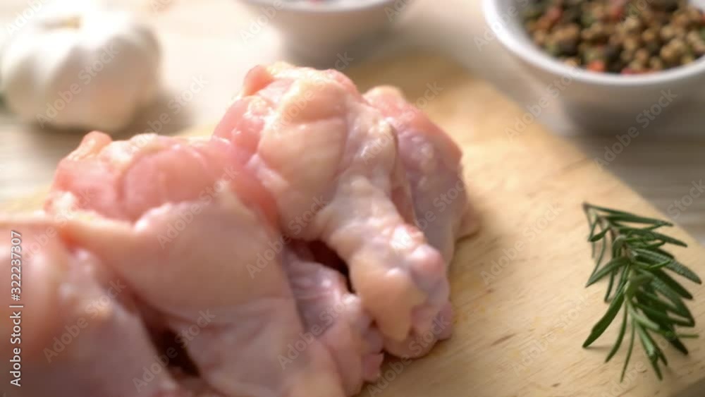 fresh raw chicken wings (drumette or drumstick) on wooden board with ingredients fresh raw chicken wings (drumette or drumstick) on wooden board with ingredients