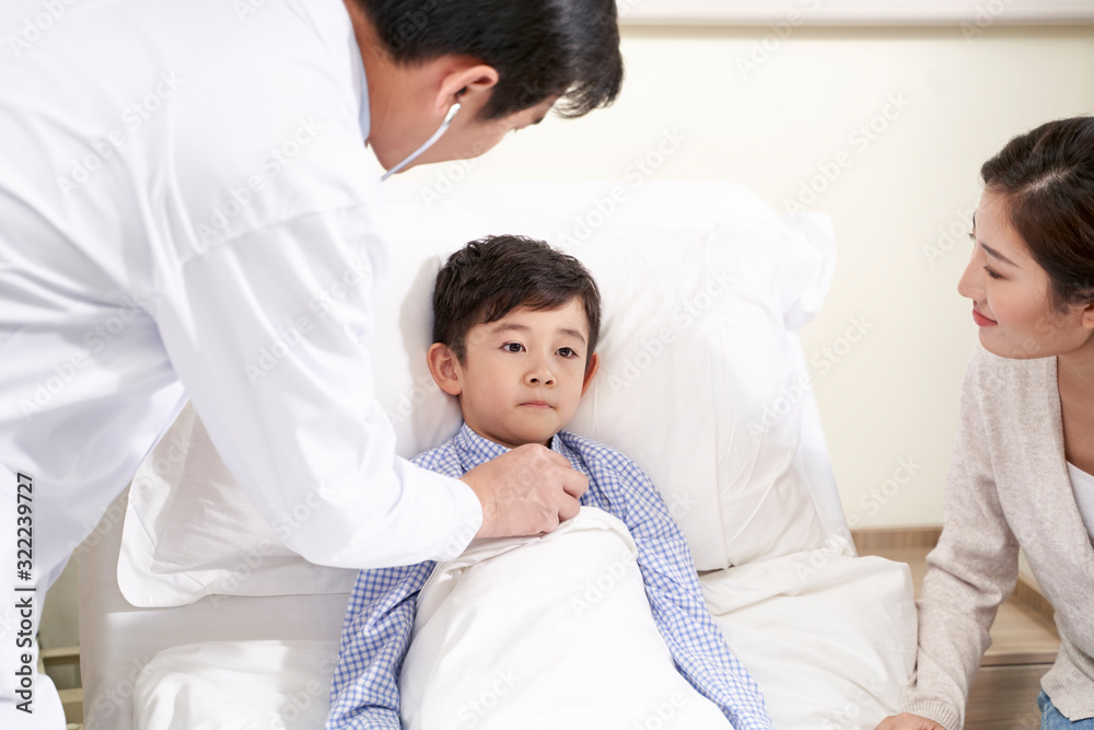 asian pediatrician examining child using stethoscope asian pediatrician examining child using stethoscope
