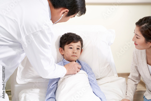 asian pediatrician examining child using stethoscope