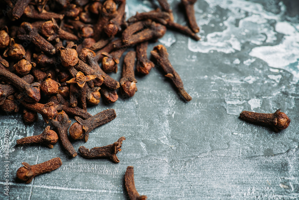 Dry cloves spices on the dark rustic background. Selective focus. shallow depth of field. Dry cloves spices on the dark rustic background. Selective focus. shallow depth of field.