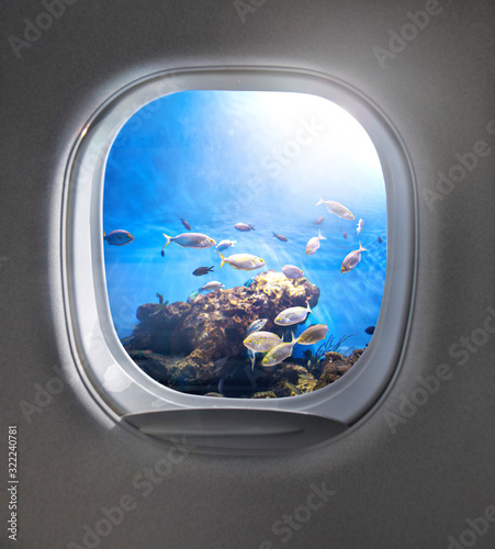 View of cloudy blue clear sky through airplane porthole.