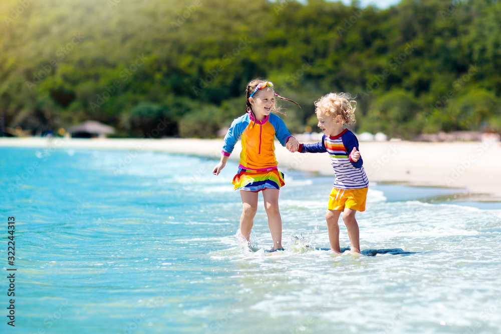 Kids on tropical beach. Children playing at sea. Kids on tropical beach. Children playing at sea.