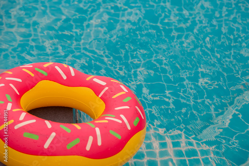 Rubber ring in blue swimming pool