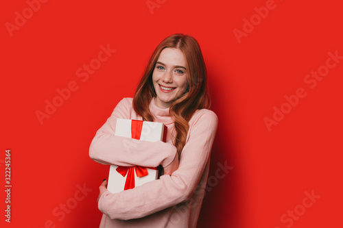 The image of a cheerful lady being happy after she had received a present from the company is working in © Strelciuc