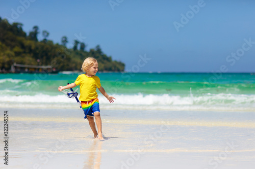 Child snorkeling on tropical beach. Kids snorkel.