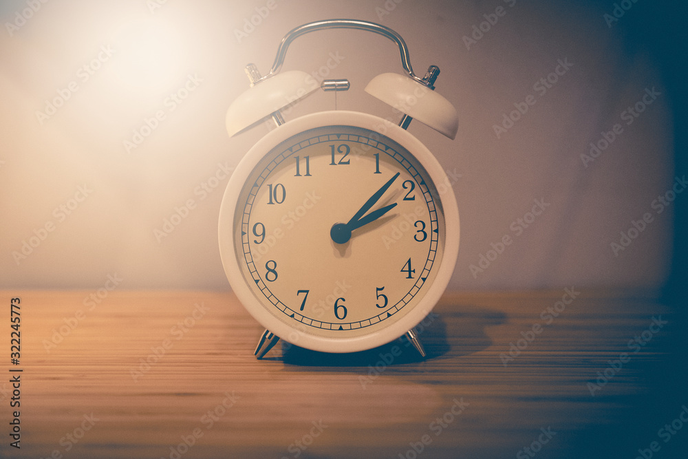 Alarm clock on the wood table beside the bed Alarm clock on the wood table beside the bed
