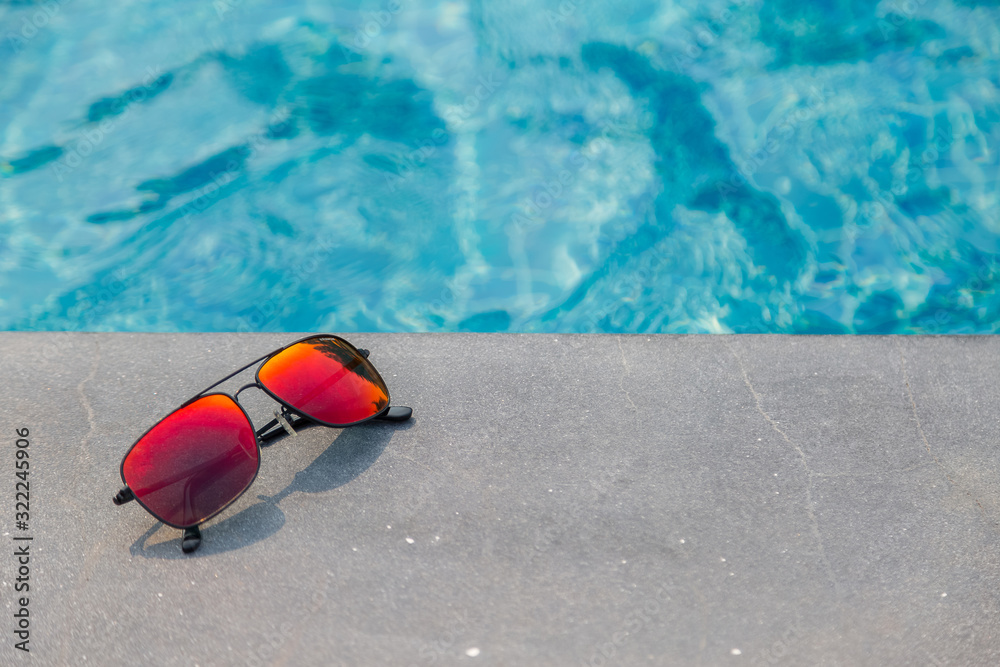 Fashion sun glasses near the swimming pool