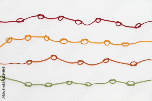 4 color strings line pattern on white background with knot 