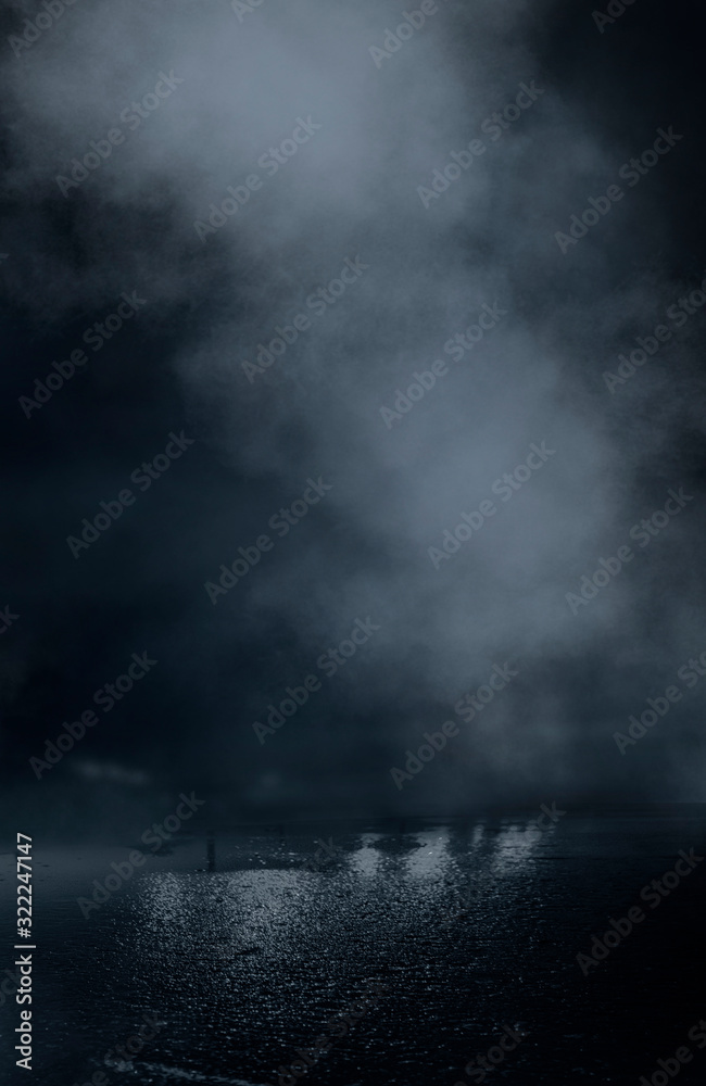 Wet asphalt, reflection of neon lights, a searchlight, smoke. Abstract light in a dark empty street with smoke, smog. Dark background scene of empty street, night view, night city.