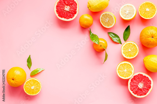 Fototapeta Naklejka Na Ścianę i Meble -  Fresh citrus frame. Oranges, tangerines, grapefruits, leaves on pink background top-down copy space