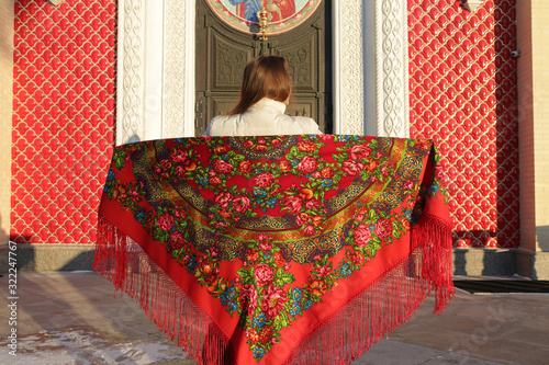 Russian tourist girl in vintage Pavlovo Posad shawl, look. Orthodox Saint Igor Chernigovsky's church in Novo-Peredelkino, Moscow city, Russia. Russian traditional national folk, retro style in fashion photo