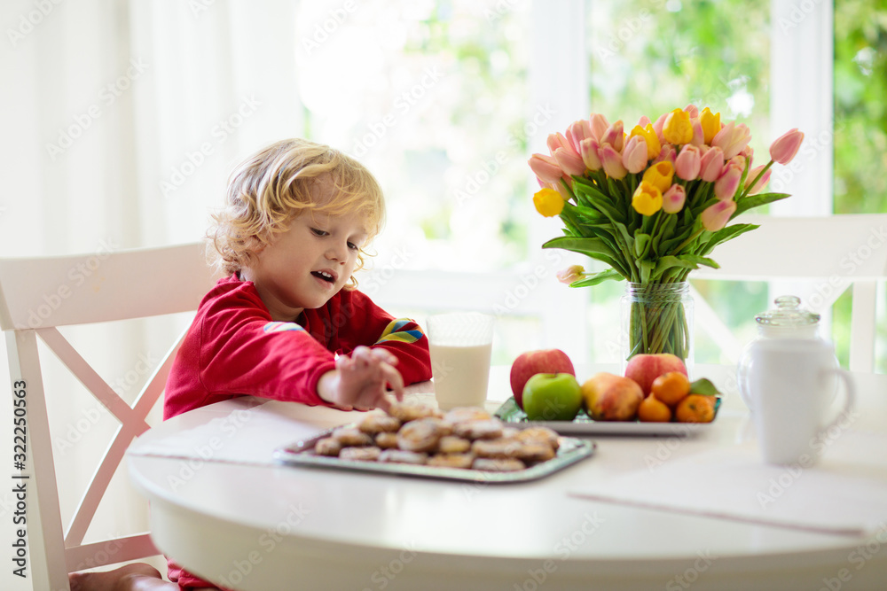 Child eating breakfast. Kid drinking milk. Child eating breakfast. Kid drinking milk.