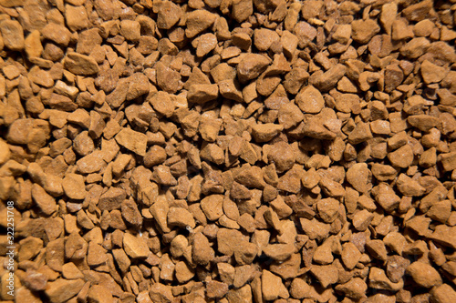 Brown dried granulated coffee background close up like earth