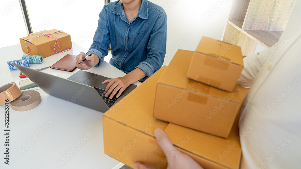 Startup small business entrepreneur SME, young asian man working with laptop computer and delivery packaging box, online market packing, SME e-commerce seller concept. Startup small business entrepreneur SME, young asian man working with laptop computer and delivery packaging box, online market packing, SME e-commerce seller concept.