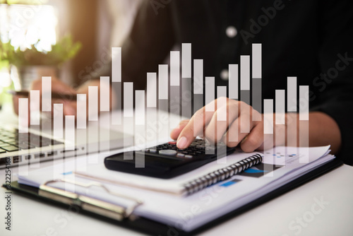 Male businessman working on desk office with using a calculator to calculate the numbers, finance accounting concept.