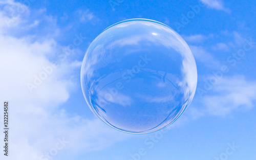 Bubble soap on blue sky with clouds background texture in bright morning. 3d ball  round circle. Transparent glass sphere for clean atmosphere. Nature abstract white cloudscape in sunny day.